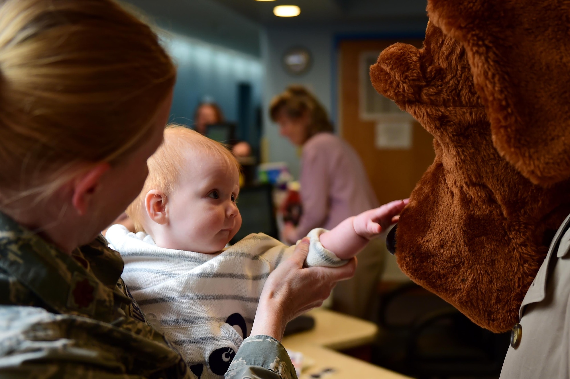 A Buckley Air Force Base child interacts with McGruff the Crime Dog May 9, 2016, at the Crested Butte Child Development Center on Buckley AFB, Colo. McGruff visited with children for Police Week which salutes those who aim to maintain public safety every day. (U.S. Air Force photo by Airman 1st Class Gabrielle Spradling/Released)