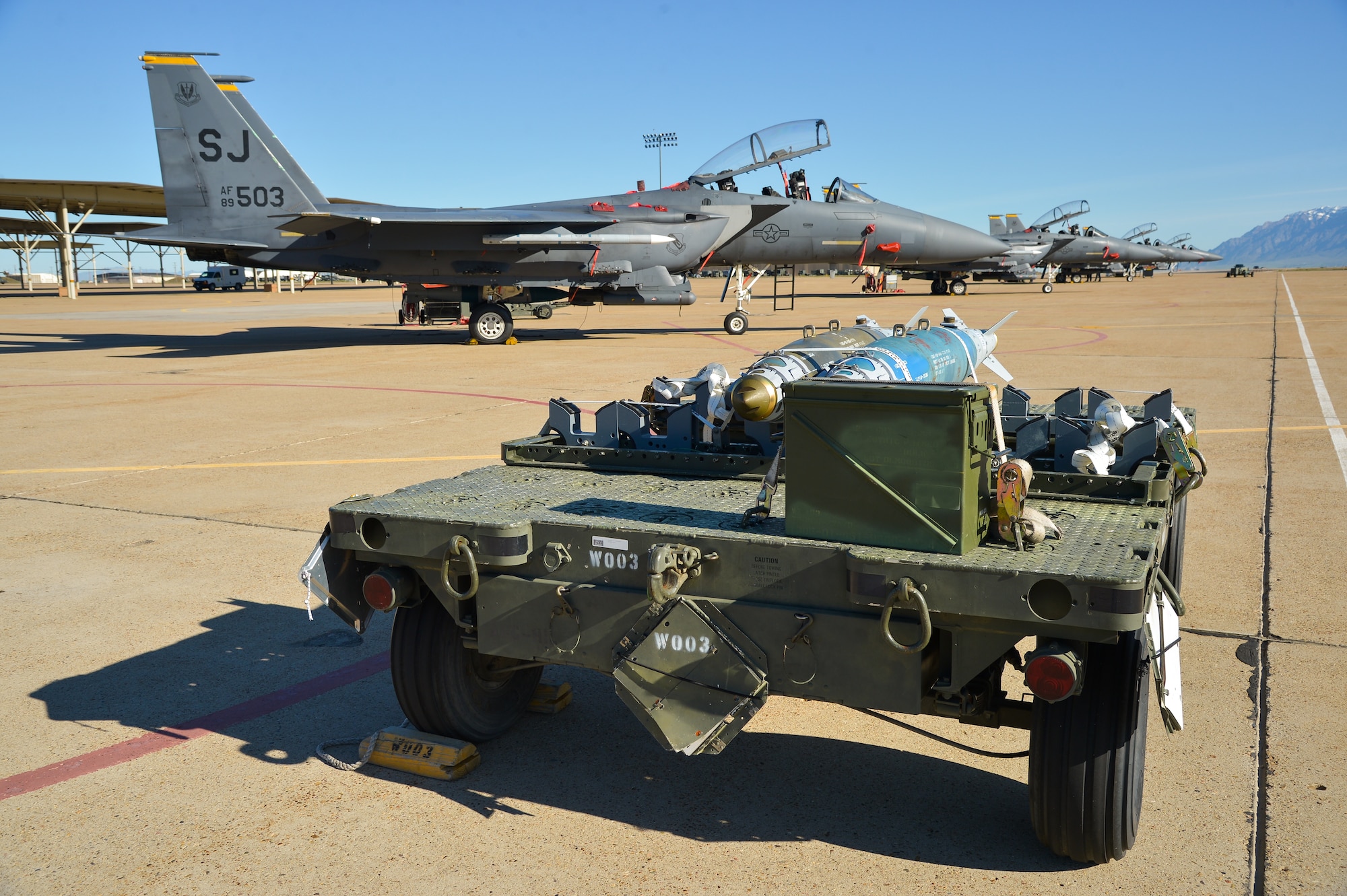 Munitions sit on the aircraft ramp at Hill Air Force Base, Utah, May 3, 2016, waiting to be loaded onto F-15E Strike Eagle aircraft from Seymour Johnson AFB, North Carolina. The F-15Es, along with other fighter and bomber aircraft, participated in the U.S. Air Force air-to-ground weapons evaluation known as Combat Hammer. Combat Hammer, which runs until May 14, tests and validates the performance of crews, pilots and their technology while deploying precision-guided munitions. (U.S. Air Force photo by R. Nial Bradshaw)