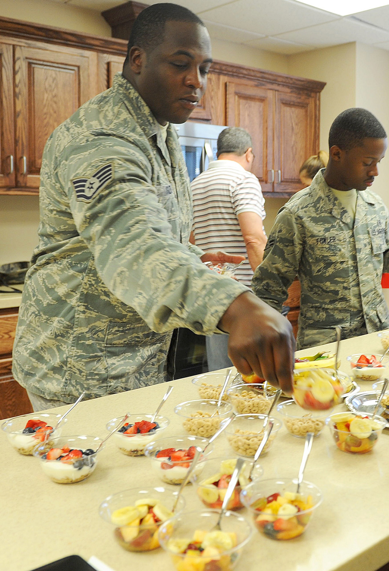 Dorm airmen sample the first goodies made in their new kitchen, May 9, 2016. (U.S. Air Force photo by Tommie Horton)
