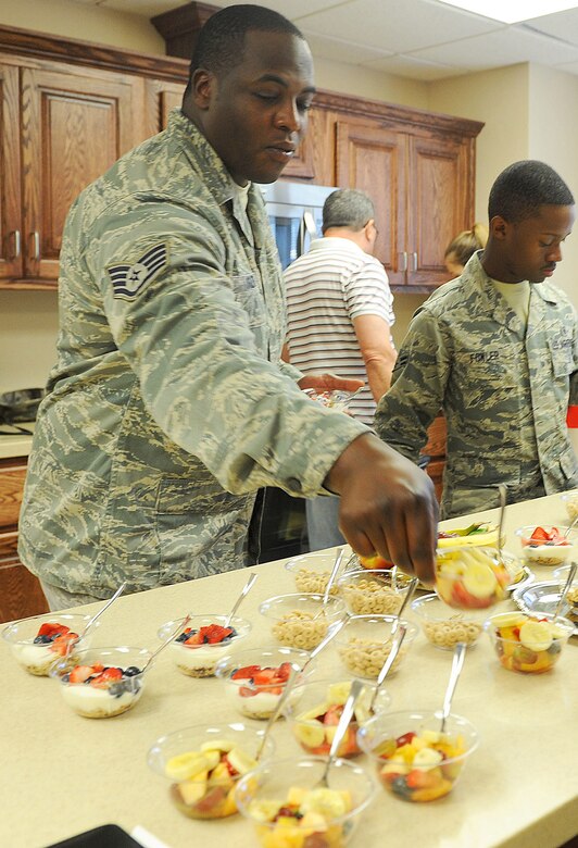 Dorm airmen sample the first goodies made in their new kitchen, May 9, 2016. (U.S. Air Force photo by Tommie Horton)
