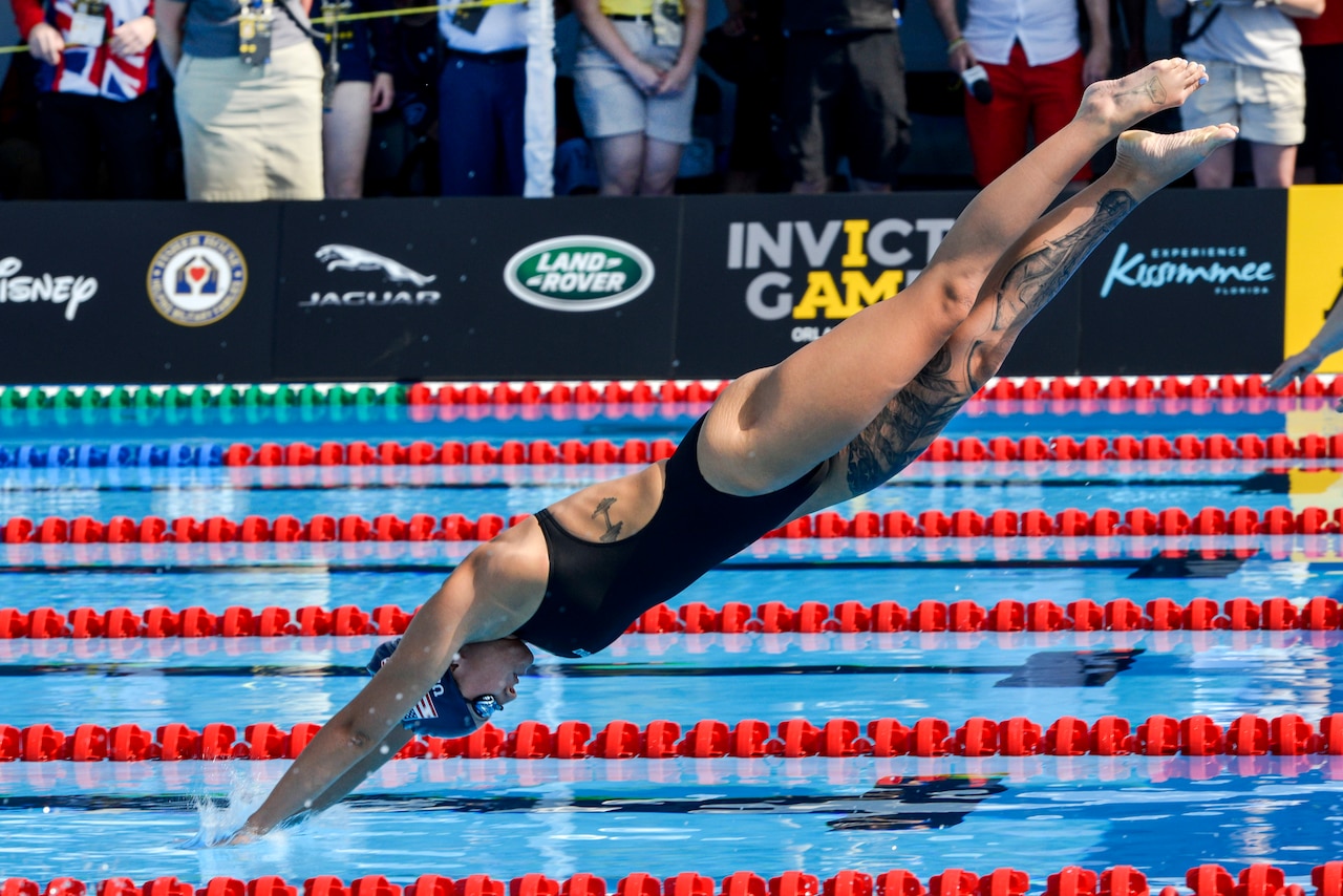 Army Sgt. Elizabeth Marks enters the water in the breaststroke finals at the 2016 Invictus Games in Orlando, Fla., May 11, 2016. Air Force photo by Senior Master Sgt. Kevin Wallace