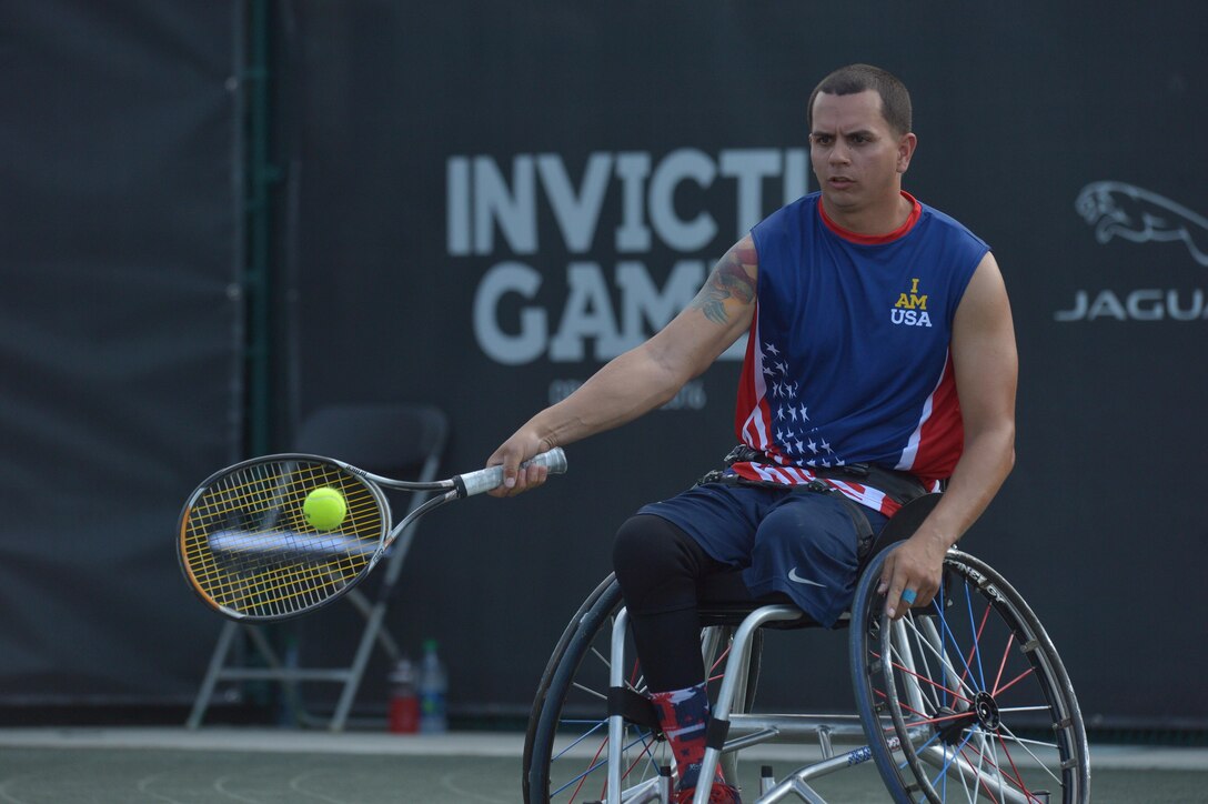Navy veteran Javier Rodriguez prepares to hit a return shot in the wheelchair tennis semifinals at the 2016 Invictus Games in Orlando, Fla., May 11, 2016. Army photo by Staff Sgt. Alex Manne