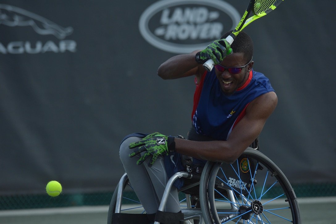 Army veteran R.J. Anderson hits a low return shot in the wheelchair tennis semifinals during the 2016 Invictus Games in Orlando, Fla., May 11, 2016. Army photo by Staff Sgt. Alex Manne