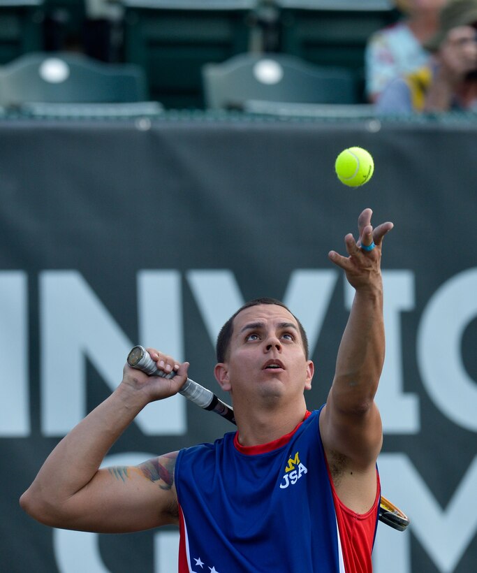 Navy veteran Javier Rodriguez serves a ball in the wheelchair tennis semifinals during the 2016 Invictus Games in Orlando, Fla., May 11, 2016. Army photo by Staff Sgt. Alex Manne