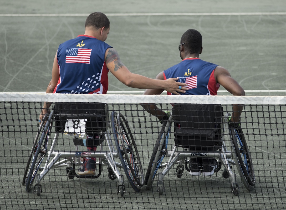 Army veteran R.J. Anderson, right, and Navy veteran Javier Rodriguez leave the court after playing the New Zealand team in the wheelchair tennis semifinals at the 2016 Invictus Games in Orlando, Fla., May 11, 2016. DoD photo by Roger Wollenberg