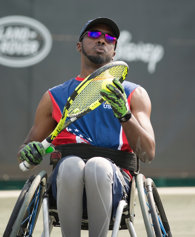 Army veteran R.J. Anderson scans the court as he prepares to serves a ball in the wheelchair tennis semifinals during the 2016 Invictus Games in Orlando, Fla., May 11, 2016. DoD photo by Roger Wollenberg