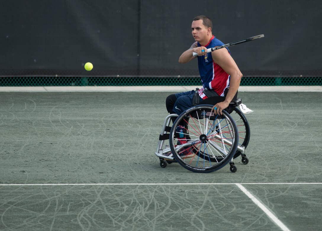 Navy veteran Javier Rodriguez returns a ball in the wheelchair tennis semifinals during the 2016 Invictus Games in Orlando, Fla., May 11, 2016. DoD photo by Roger Wollenberg
