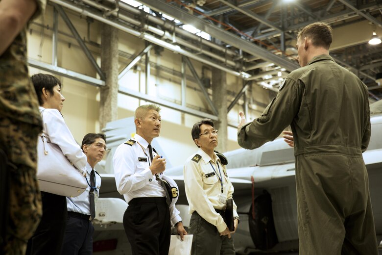 (From right to left) U.S. Marine Corps Maj. Elisha Keller, training officer with Marine All Weather Fighter Attack Squadron (VMFA(AW)) 242, explains air support operations to Japan Ground Self-Defense Force Col. Mitsuhiko Nakadai, Japan Maritime Self-Defense Force Capt. Atsushi Tanaka, Japan Air Self-Defense Force Lt. Col Kiyoshi Oda and JMSDF Capt. Madoka Sato, instructors from the Japanese Joint Staff College, instructors from the Japanese Joint Staff College, during their visit to Marine Corps Air Station Iwakuni, Japan, May 9, 2016. The Japanese Joint Staff College instructors visited MCAS Iwakuni to learn about Marine Air-Ground Task Force operations. (U.S. Marine Corps photo by Lance Cpl. Donato Maffin/Released) 