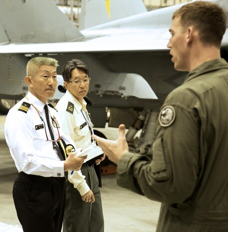 U.S. Marine Corps Maj. Elisha Keller, training officer with Marine All-Weather Fighter Attack Squadron (VMFA(AW)) 242, explains air support operations to Japan Ground Self-Defense Force Col. Mitsuhiko Nakadai and Japan Maritime Self-Defense Force Capt. Atsushi Tanaka, instructors from the Japanese Joint Staff College, during their visit to Marine Corps Air Station Iwakuni, Japan, May 9, 2016. The Japanese Joint Staff College instructors visited MCAS Iwakuni to learn about Marine Air-Ground Task Force operations. (U.S. Marine Corps photo by Lance Cpl. Donato Maffin/Released) 