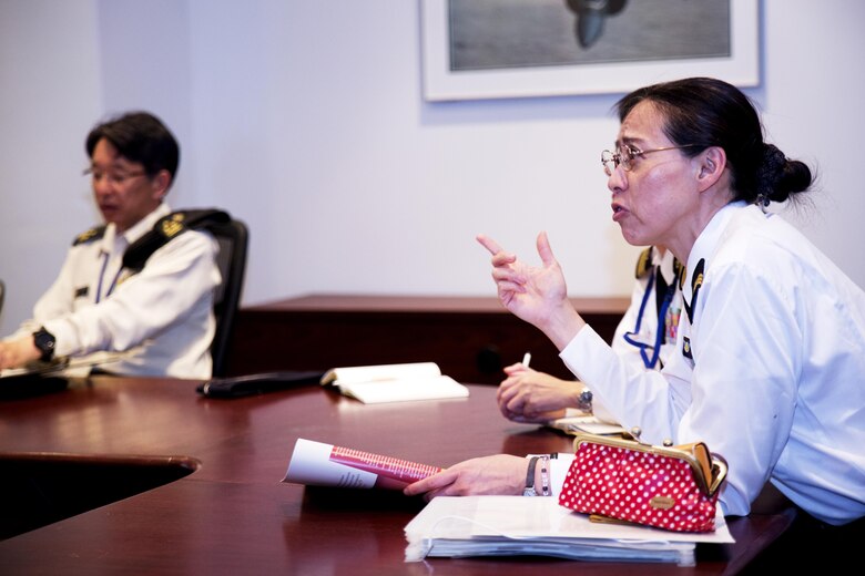 Japan Maritime Self-Defense Force Cmdr. Hiroko Takigawa (left) and Japan Ground Self-Defense Force Col. Mitsuhiko Nakadai, instructors from the Japanese Joint Staff College, participate in the welcome aboard brief during their visit to Marine Corps Air Station Iwakuni, Japan, May 9, 2016. The Japanese Joint Staff College instructors visited MCAS Iwakuni to learn about and Marine Air-Ground Task Force operations. (U.S. Marine Corps photo by Lance Cpl. Donato Maffin/Released)