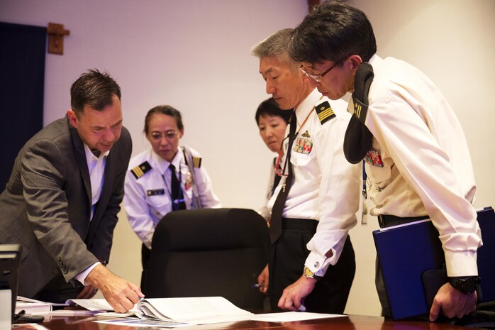 U.S. Marine Corps Lt. Col. Gary W. Thomason, exeutive officer of Marine Corps Air Station Iwakuni, discusses military operations with Japan Ground Self-Defense Force Col. Mitsuhiko Nakadai, Japan Maritime Self-Defense Force Capt. Atsushi Tanaka, JMSDF Capt. Madoka Sato and JMSDF Cmdr. Hiroko Takigawa, instructors from the Japanese Joint Staff College, during their visit to the air station in Iwakuni, Japan, May 9, 2016. The Japanese Joint Staff College instructors visited MCAS Iwakuni to learn about Marine Air-Ground Task Force operations. (U.S. Marine Corps photo by Lance Cpl. Donato Maffin/Released) 