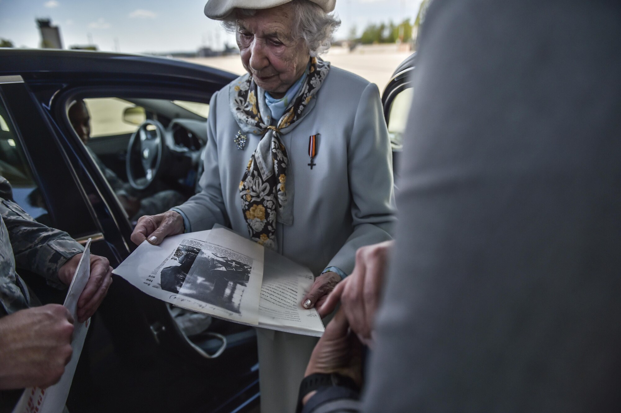 Ms. Selma Van de Perre, 92-year-old Holocaust survivor, shows an old London-based newspaper article that she was featured in after receiving the Dutch Resistance Cross at Ramstein Air Base, Germany, May 6, 2016. Van de Perre was awarded the cross many years after surviving Ravensbrück, a women’s concentration camp during the Holocaust. (U.S. Air Force photo/Tech Sgt. Sara Keller) 