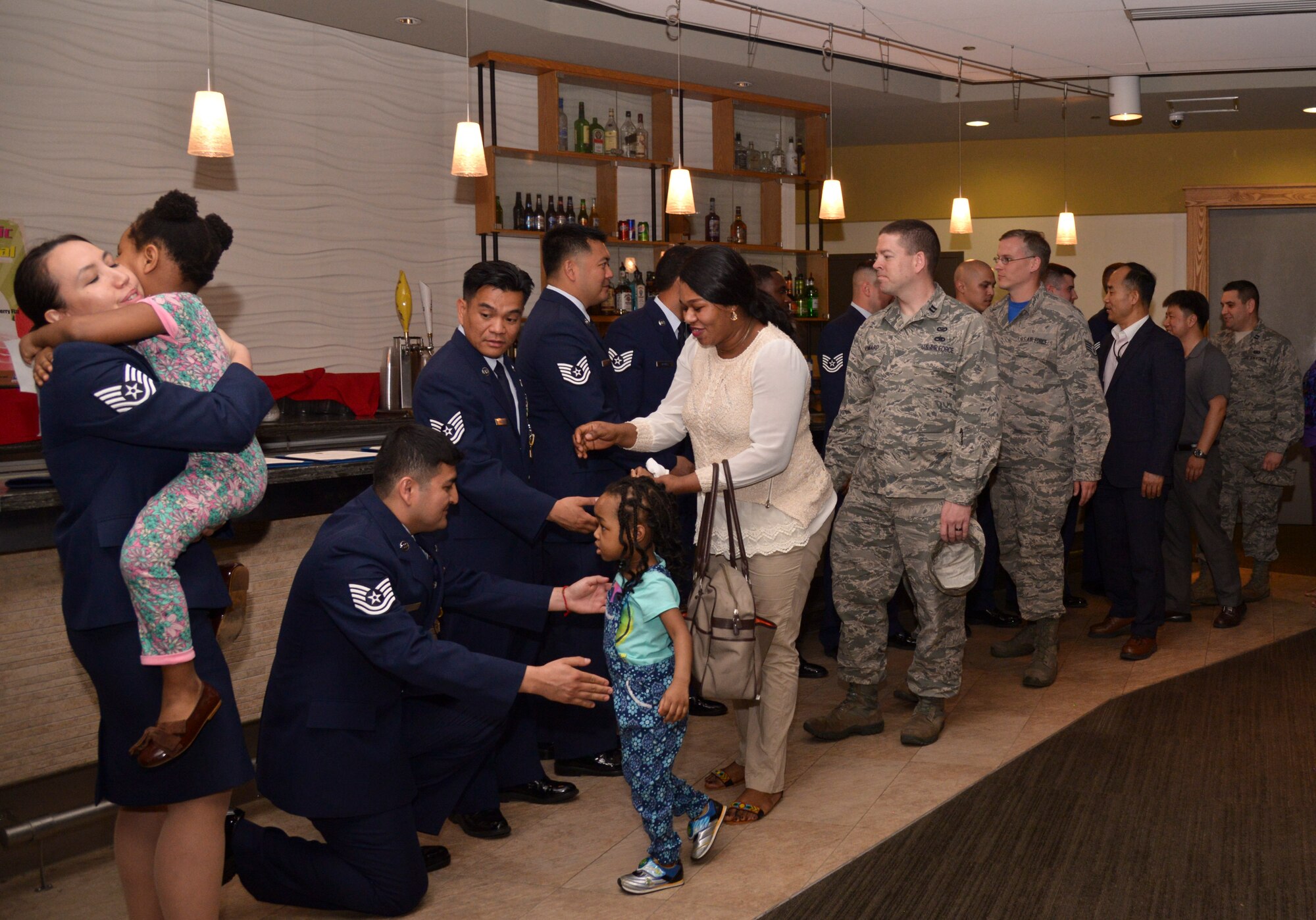 The Enyioko family along with members of Team Osan line up to shake hands with the individuals involved in the Songtan fire rescue after a recognition ceremony at Osan Air Base, Republic of Korea, May 13, 2016. Each Airman and Soldier involved with the rescue received an Air Force Commendation Medal and the civilian received a Command Civilian Award For Valor. (U.S. Air Force photo by Tech. Sgt. Travis Edwards)