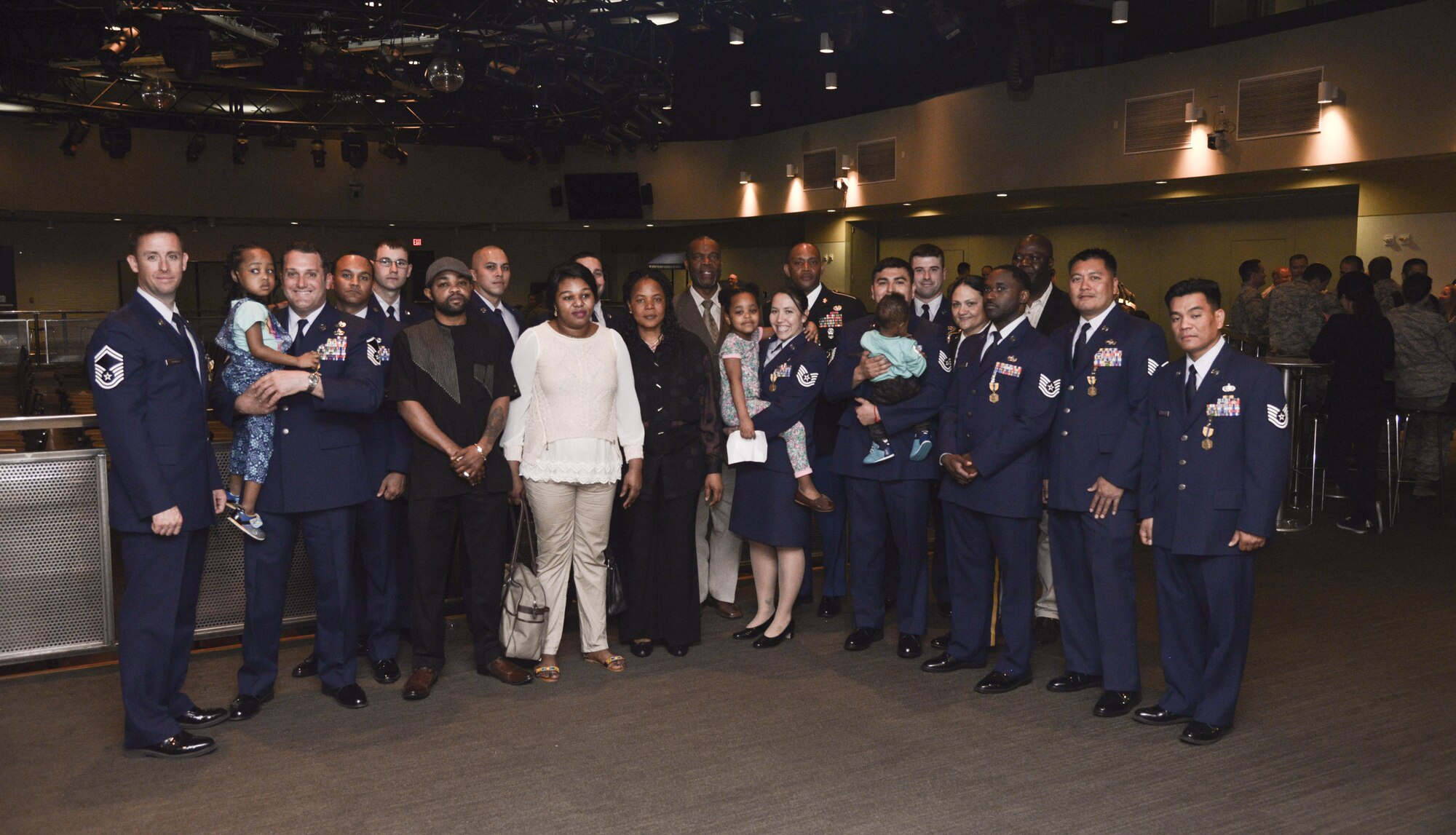 Airmen, Soldiers , and the Enyioko family along with their sister and pastor pose for a group photo at Osan Air Base, Republic of Korea, May 13, 2016. The photo was taken after an award ceremony recognizing the team of Airmen and Soldiers who saved the lives of four locals from a burning building in Songtan, Republic of Korea. Each Airman and Soldier involved with the rescue received an Air Force  Commendation Medal and the civilian received a Command Civilian Award For Valor. (U.S. Air Force photo by Tech. Sgt. Travis Edwards)