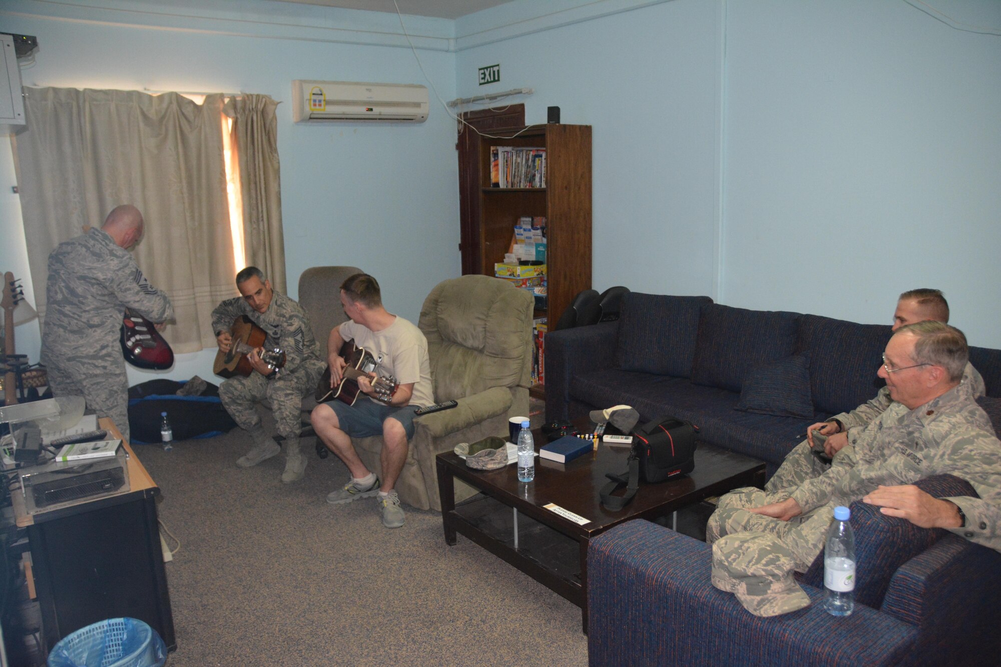 Air Forces Central Command Chief Master Sgt. Ramon Colon-Lopez plays guitar with Airman during a visit to Eskan Village, Southwest Asia, August 24, 2015. Playing instruments is a way for many Airman to relax and bond during deployments. (Courtesy photo)