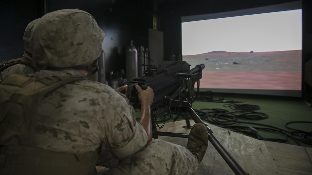 A Marine with Weapons Company, 2nd Battalion, 2nd Marine Regiment, fires on virtual targets with a Mk 19 automatic grenade launcher during training at the Indoor Simulated Marksmanship Trainer at Marine Corps Base Camp Lejeune, North Carolina, Aug. 5, 2015. The ISMT allows training with a variety of simulated weapons including Mk 19s, M2 50-caliber machine guns, M240 medium machine guns and M16 service rifles. 