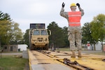Members of the Minnesota National Guard load vehicles and equipment onto rail cars, at Camp Ripley, for movement to a training site out of state Sept. 18, 2015. Similar evolutions are underway now as the Minnesota Guard prepares for a massive rail convoy.
