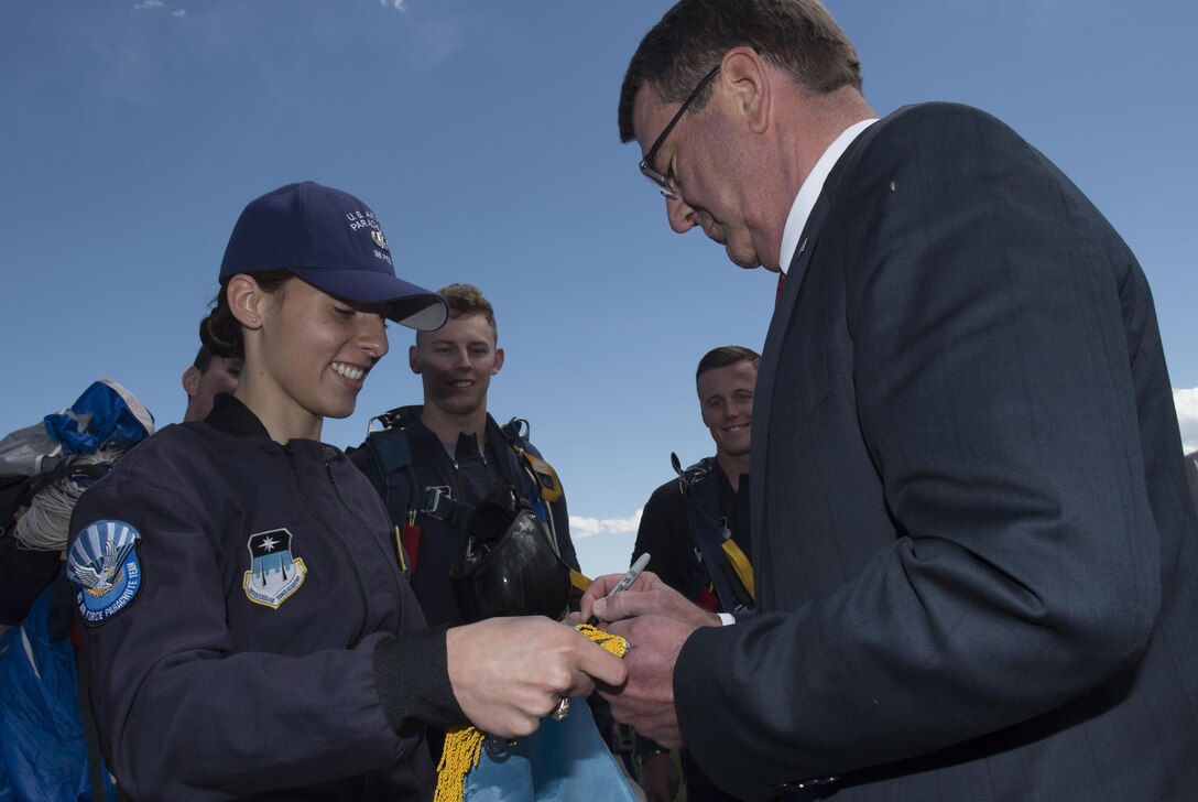 Defense Secretary Ash Carter autographs a flag for the U.S. Air Force Academy parachute team in Colorado Springs, Colo., May 12, 2016. DoD photo by Air Force Senior Master Sgt. Adrian Cadiz