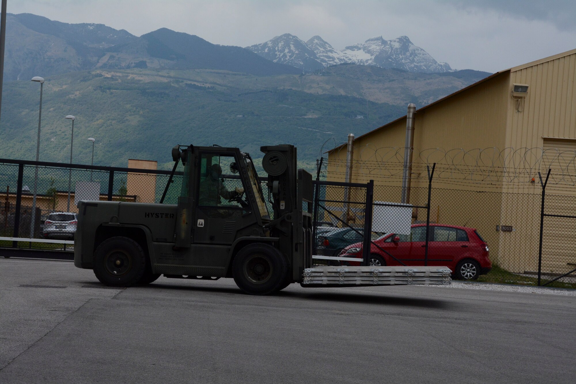 Staff Sgt. Malcolm Jenkins, 71st Aerial Port Squadron, drives a 10k forklift to download cargo from K-Loader vehicles May 4, 2016, Aviano Air Base, Italy. Jenkins specializes in the Air Terminal Operations Center of the air transportation career field and is using this job proficiency-enhancing tour to refresh his training in cargo processing. (U.S. Air Force photo/Tech. Sgt. Mercedes Crossland)