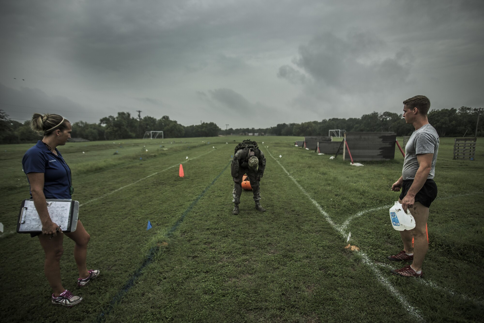 An Airman completes an obstacle course while wearing a 20-pound vest and a 50-pound rucksack, June 19, 2015, as researchers from the Air Force Fitness Testing and Standards Unit observe. The Airman is a volunteer in the fitness study, which supported the Air Force’s Women in Service Review. The Battlefield Airmen Physical Fitness Study Team developed a prototype PT test that is indicative of the physical capabilities needed for combat. All male and female subjects underwent 39 physical fitness tests and 15 physical task simulations to link fitness tests and standards to real world operational tasks and requirements. (U.S. Air Force photo by Capt. Jose R. Davis)