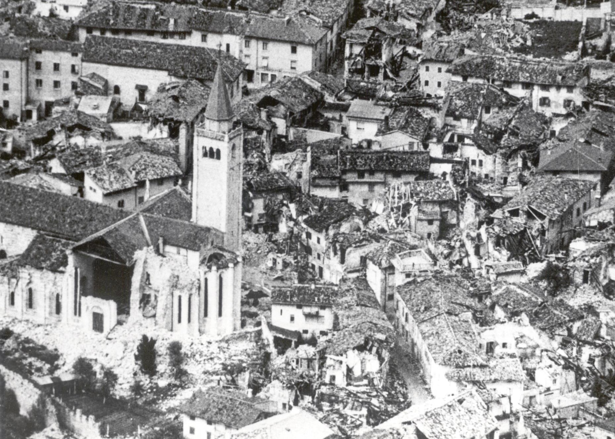 An aerial view shortly after the Friuli Earthquake on May 6th, 1976, in Gemona, Italy. The following 12 months, hundreds of more tremors continued as construction efforts pushed on. The largest tremors struck September 11 and 15, when four aftershocks of 5.4-6.0 magnitudes caused additional damage and human casualties. (U.S. Air Force photo)