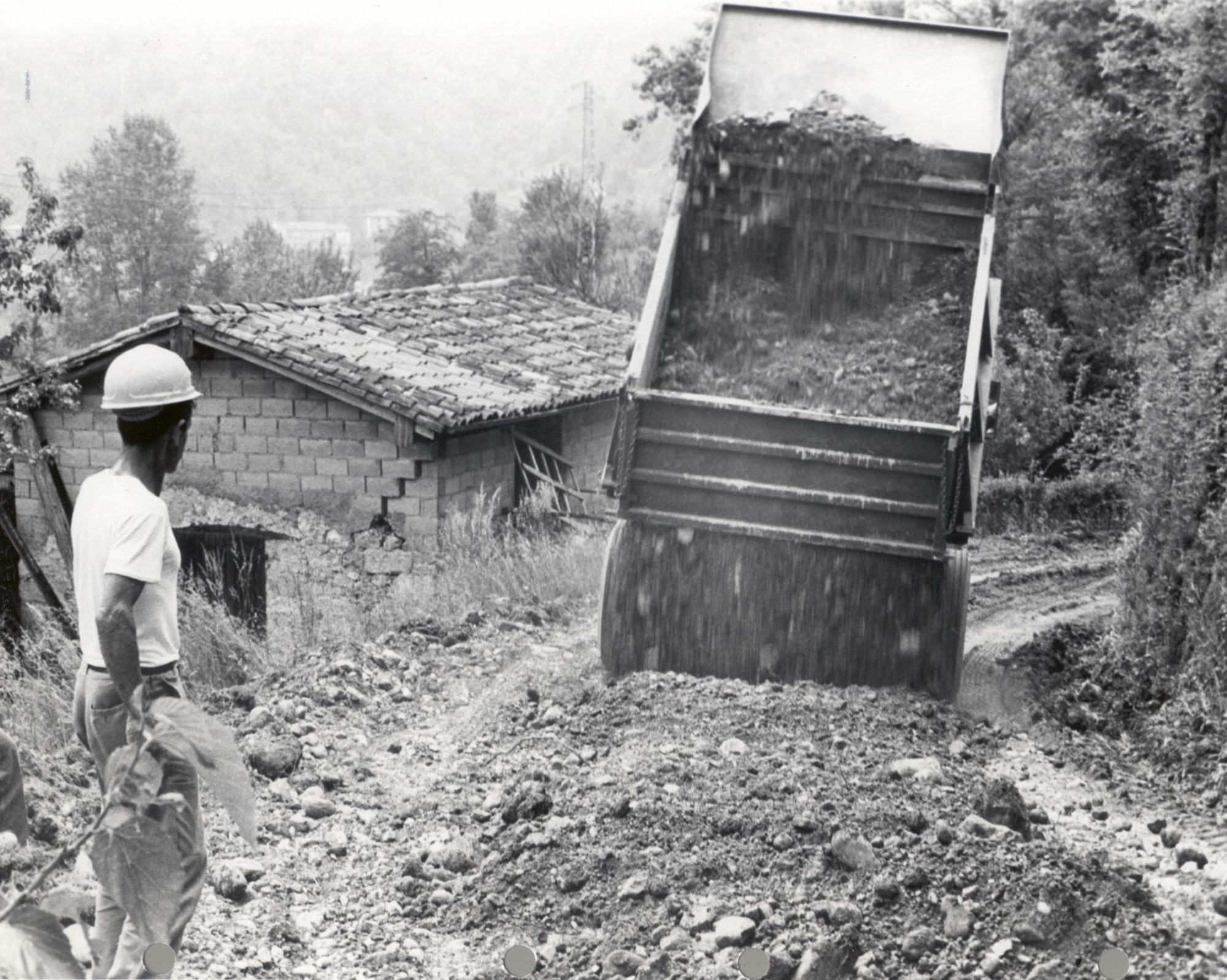 Airmen from the 40th Tactical Group, now the 31st Fighter Wing, lay dirt for a road during relief efforts following the Friuli Earthquake May 6, 1976, in Gemona, Italy. Tremors continued for the next 12 months resulting in more than 950 deaths, 2,400 injured and 45,000 to homeless. (U.S. Air Force photo)
