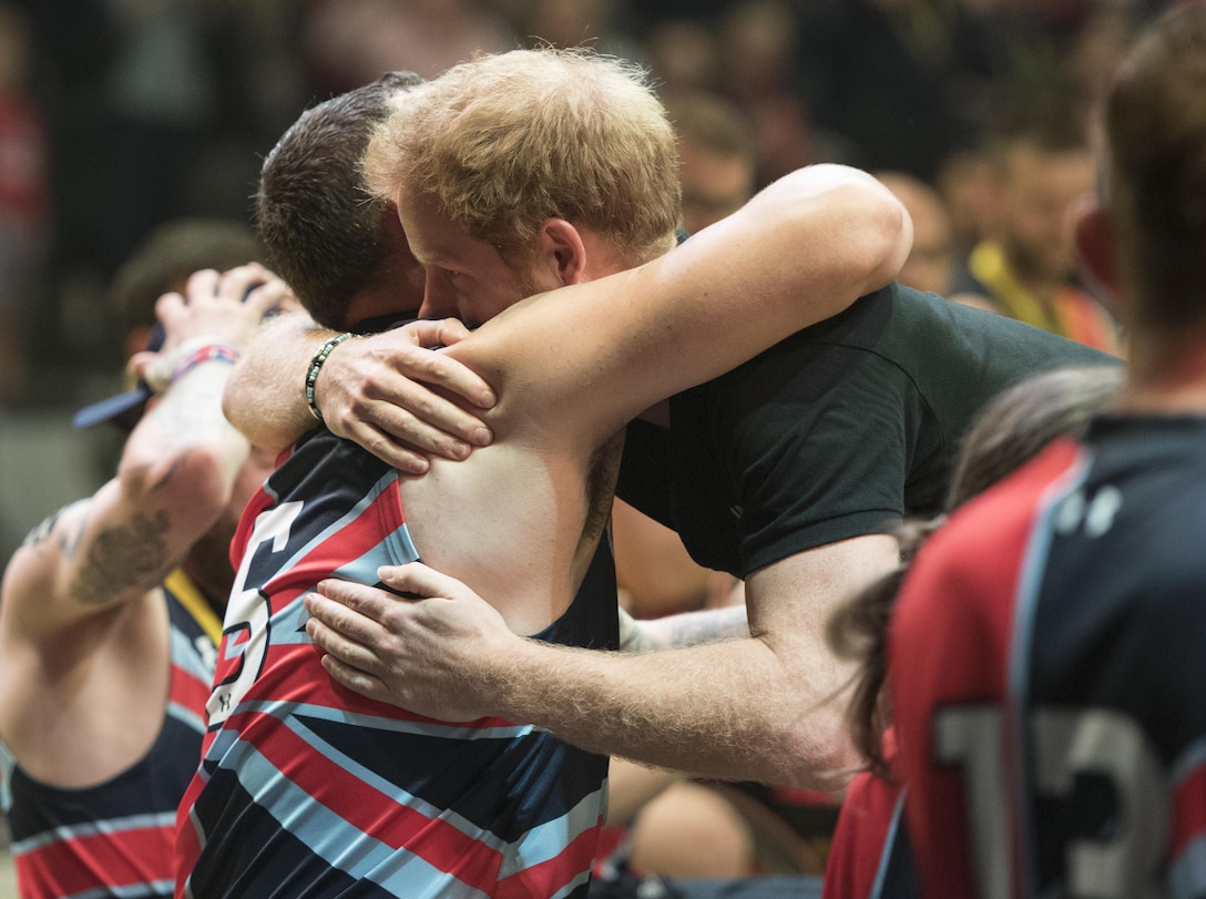 Prince Harry, right, hugs Great Britain’s Craig Winspear after awarding him a silver medal in wheelchair basketball during the 2016 Invictus Games in Orlando, Fla., May 12, 2016. DoD photo by Roger Wollenberg
