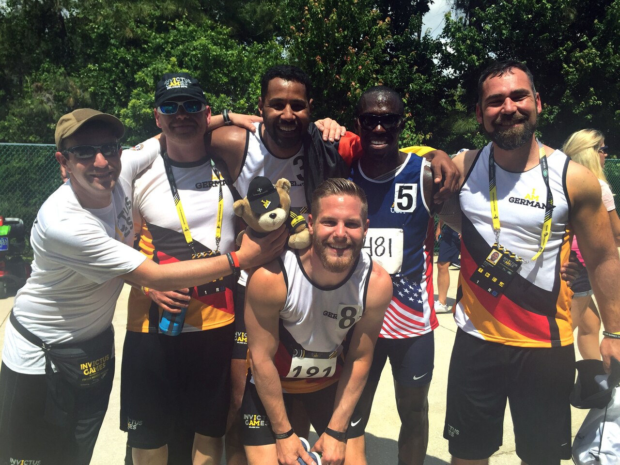 Army Reservist Staff Sgt. Zed Pitts stops for a photo with his German friend, fellow runner, 1st Sgt. Naef Adebahr and his friends after Adebahr received his bronze in the men's 200-meter dash and Pitts received his silver in the men's 100-meter dash in their respective disability categories during the track and field competition at the Invictus Games at the ESPN Wide World of Sports, Walt Disney World, Orlando, Fla., May 10, 2016. (DoD photo by Shannon Collins)