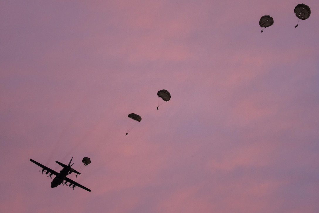 Marines jump from an Air Force C-130 Hercules at Yokota Air Base, Japan, May 11, 2016, during Jump Week. The Marines were from the 3rd Reconnaissance Battalion, 3rd Marine Division, III Marine Expeditionary Force and the C-130 was assigned to the 36th Airlift Squadron at Yokota AB. The training not only allowed the Marines to practice jumping, but it also allowed the Yokota aircrews to practice flight tactics and timed-package drops. (U.S. Air Force photo/Yasuo Osakabe)