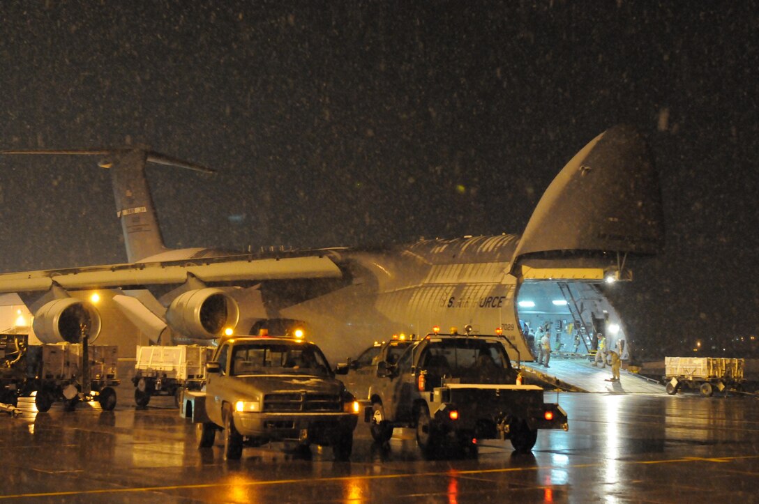 Airmen from the Minnesota Air National Guard’s 148th Fighter Wing prepare to load a C-5M Super Galaxy with electronic countermeasures for use on an F-16 Fighting Falcon on April 6, 2016. The 148th FW, an element of Air Combat Command, deployed fighter aircraft to Osan Air Base, South Korea, in order to provide U.S. Pacific Command and Pacific Air Forces with theater security packages, which help maintain a deterrent against threats to regional security and stability. (U.S. Air National photo/Tech. Sgt. Brett R. Ewald)