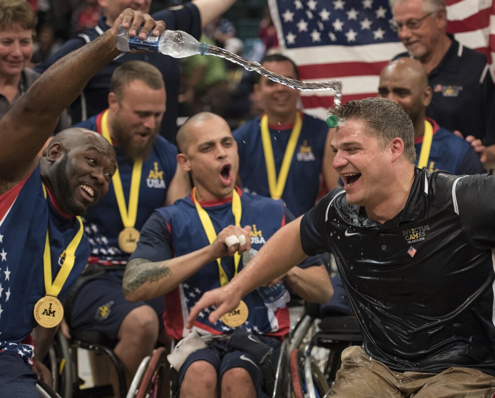 Army veteran Chuck Armstead, left, douses coach Joey Gugliotta with water as U.S. wheelchair basketball team members celebrate their gold medal win at the 2016 Invictus Games in Orlando, Fla., May 12, 2016. DoD photo by Roger Wollenberg
