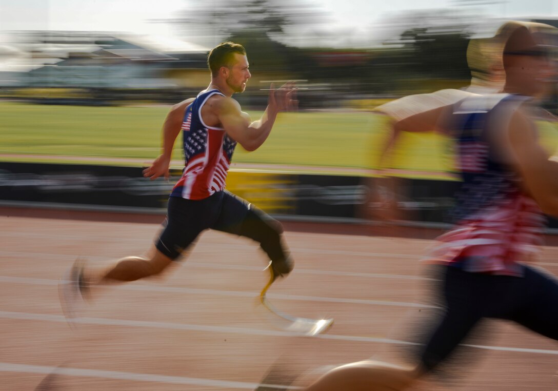 Tech. Sgt. Benjamin Seekell, of Team U.S., sprints during the male 100-meter track finals at the ESPN Wide World of Sports Complex in Orlando, Fla., May 10, 2016. The 2016 Invictus Games kicked off with a ceremony May 8, and 15 nations competed through May 12 in multiple adaptive sports events. (U.S. Air Force photo/Senior Master Sgt. Kevin Wallace)