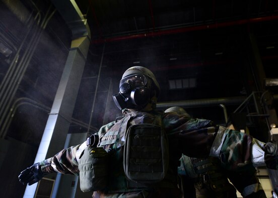 Staff Sgt. Henderson Anthony, a 51st Civil Engineer Squadron structural craftsman, stands in a cloud of decontamination powder while his mission oriented protective posture gear is decontaminated during exercise Beverly Herd 16-01 at Osan Air Base, South Korea, May 11, 2016. Dozens of civil engineer Airmen participated in the training scenario covering wartime survival skills. (U.S. Air Force photo/Senior Airman Victor J. Caputo)