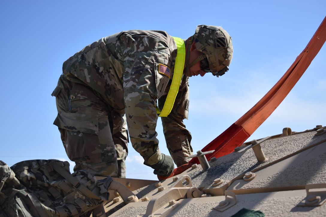 In preparation for Noble Partner 16, a U.S. soldier detaches loading straps from a Bradley Fighting Vehicle at the railhead near Vaziani Training Area, Georgia, May 5, 2016. Noble Partner will include hundreds of military personnel from the United States, Georgia and the United Kingdom. Army photo by Spc. Ryan Tatum