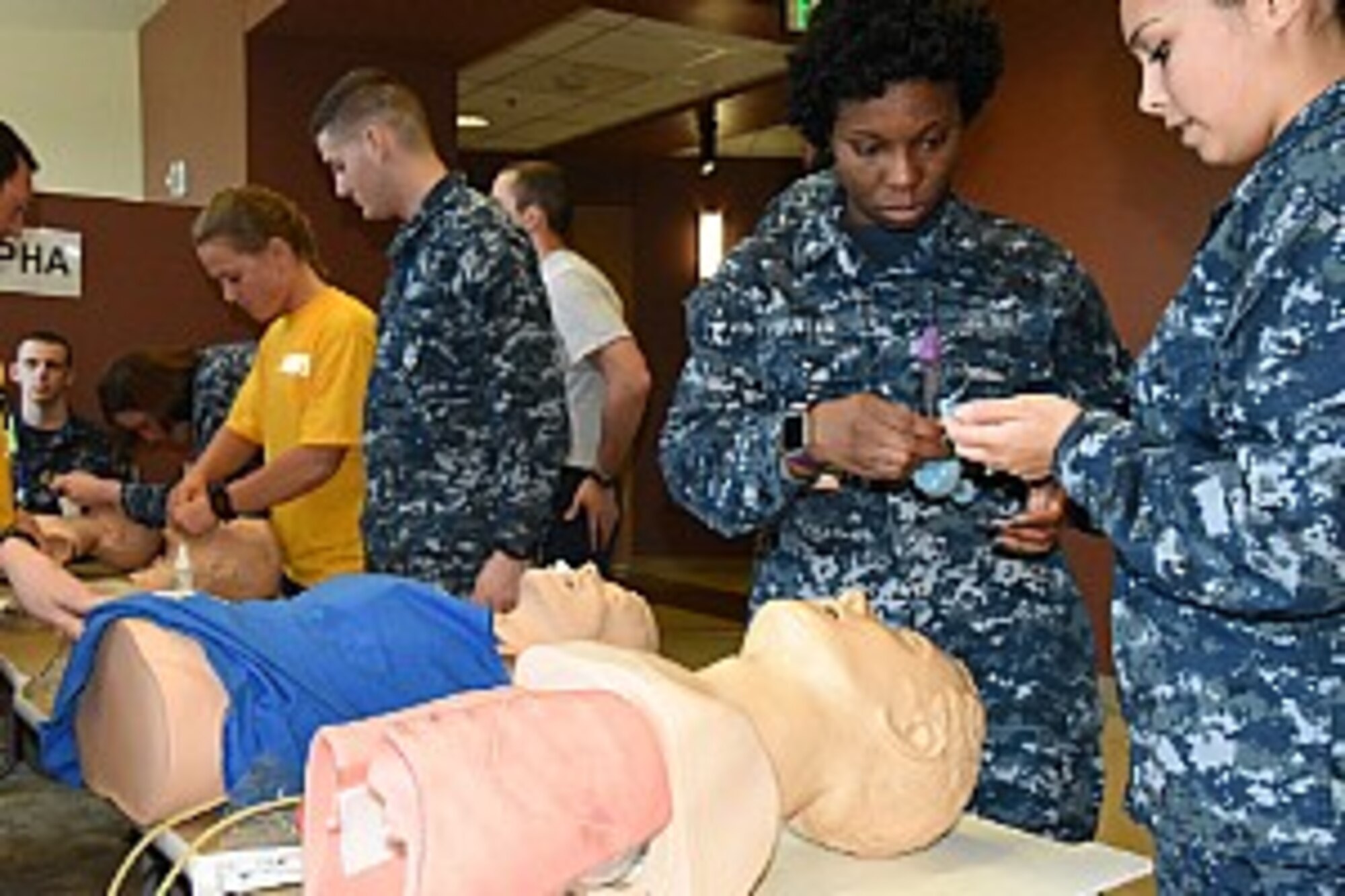 Lt. Nikki Pritchard, left, Seaman Brianna Grindle, Seaman Blake Hollier, Petty Officer 3rd Class Savasha Butler, and Seaman Brandy Sandoval, all assigned to Naval Health Clinic Charleston, practice intubation on human patient simulators, or computer-operated mannequins, May 4, 2016 during the Lowcountry Federal Healthcare Alliance Skills Wars. The joint training event is designed for military healthcare providers to hone their skills while developing camaraderie among the services. (U.S. Navy photo by Petty Officer 3rd Class Robert Jackson/Released)