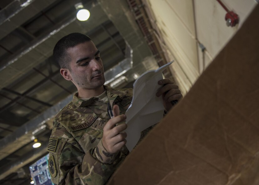 Senior Airman Michael Montalyo, 455th Expeditionary Logistics Readiness Squadron Traffic Management Office, checks the content of cargo at Bagram Airfield, Afghanistan, May 13, 2016. Members of the 455th ELRS traffic management inbound office take in and process all the cargo that comes to Afghanistan to be forwarded to other bases in the area of operation. (U.S. Air Force photo by Senior Airman Justyn M. Freeman)