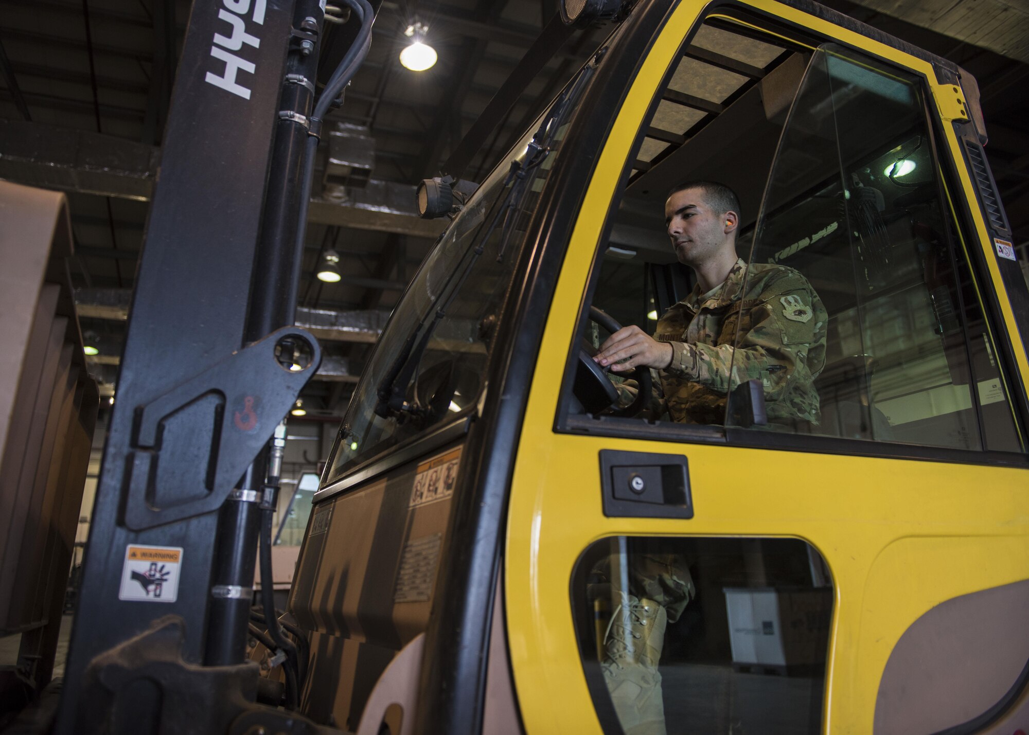 Senior Airman Michael Montalyo, 455th Expeditionary Logistics Readiness Squadron Traffic Management Office, moves shipment in a warehouse at Bagram Airfield, Afghanistan, May 13, 2016. Montalyo joins the Bargram community, for the second time, from the 60th Aerial Port Squadron out of Travis Air Force Base, California. (U.S. Air Force photo by Senior Airman Justyn M. Freeman)