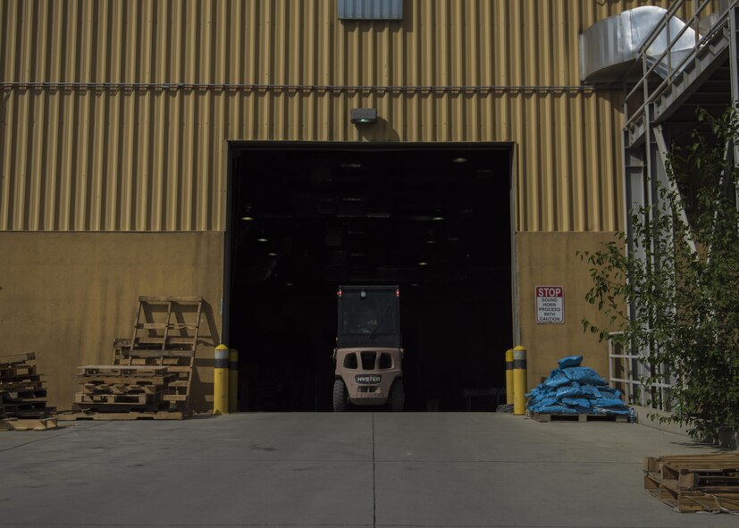 Senior Airman Michael Montalyo, 455th Expeditionary Logistics Readiness Squadron Traffic Management Office, drives a forklift back into the warehouse after moving pallets in the cargo yard at Bagram Airfield, Afghanistan, May 13, 2016. The TMO inbound section processes about 600 pieces of cargo a day, on average, to be sent out to bases in Afghanistan. (U.S. Air Force photo by Senior Airman Justyn M. Freeman)
