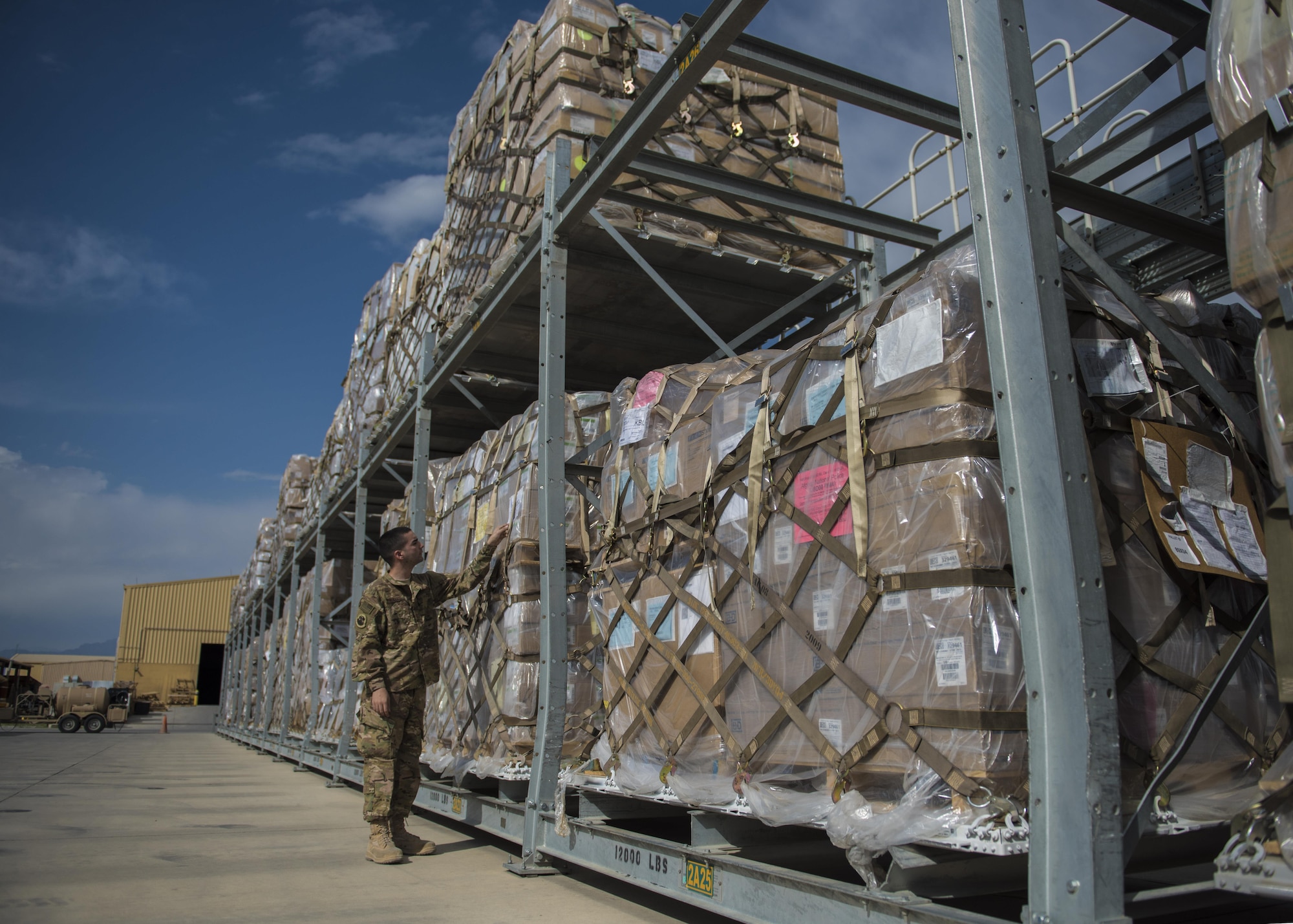 Senior Airman Michael Montalyo, 455th Expeditionary Logistics Readiness Squadron Traffic Management Office, checks shipment tags in the cargo yard at Bagram Airfield, Afghanistan, May 13, 2016. The TMO inbound section processes about 600 pieces of cargo a day, on average, to be sent out to bases in Afghanistan. (U.S. Air Force photo by Senior Airman Justyn M. Freeman)