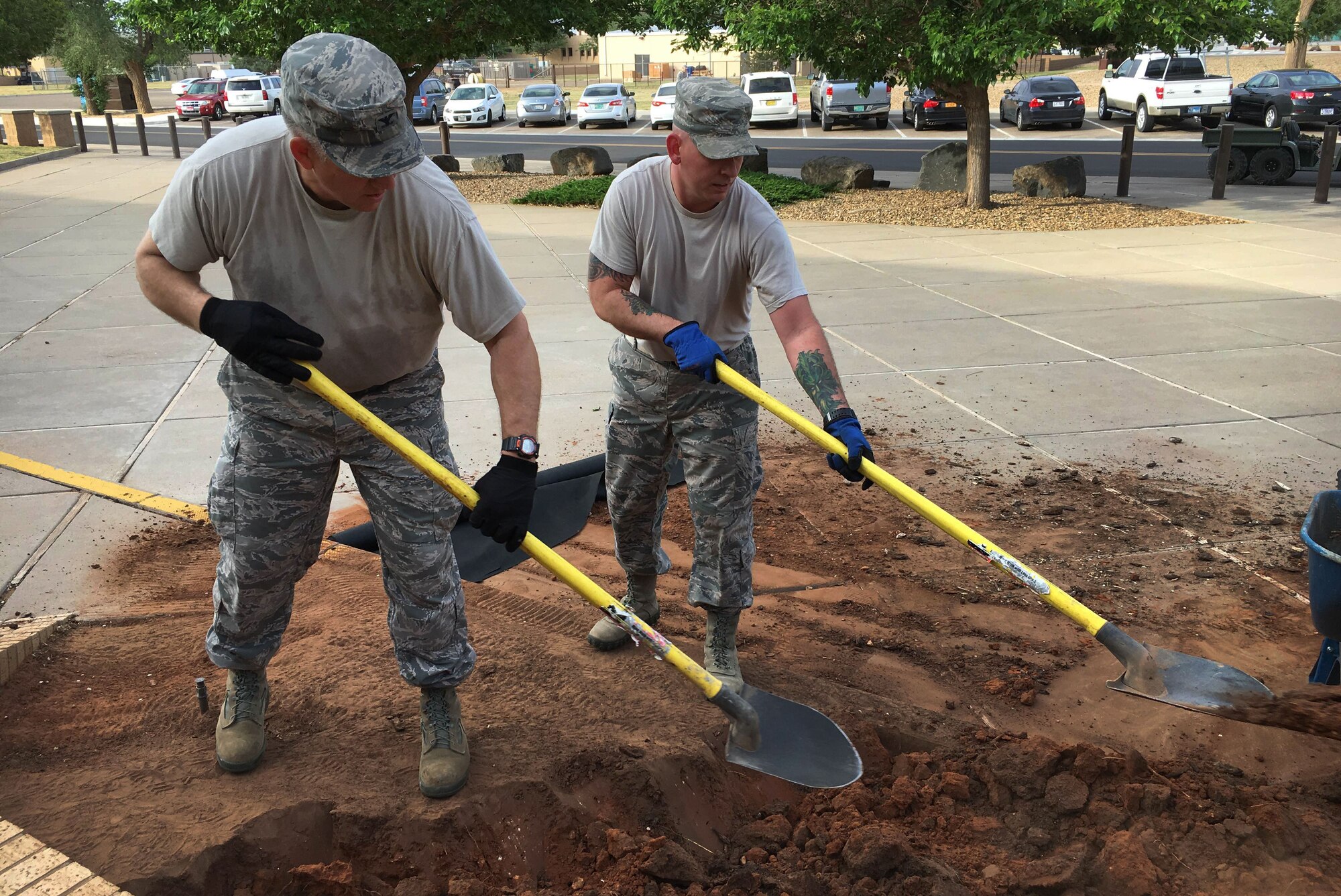 Col. Doug Gilpin, 27th Special Operations Mission Support Group commander, digs with another Air Commando outside Building 600 as part of Wing Beautification Day May 13, 2016, at Cannon Air Force Base, N.M. Air Commandos across the 27th Special Operations Wing stepped out of their work centers to demonstrate a pride epidemic for their installation. (U.S. Air Force photo/Staff Sgt. Alexx Pons)
