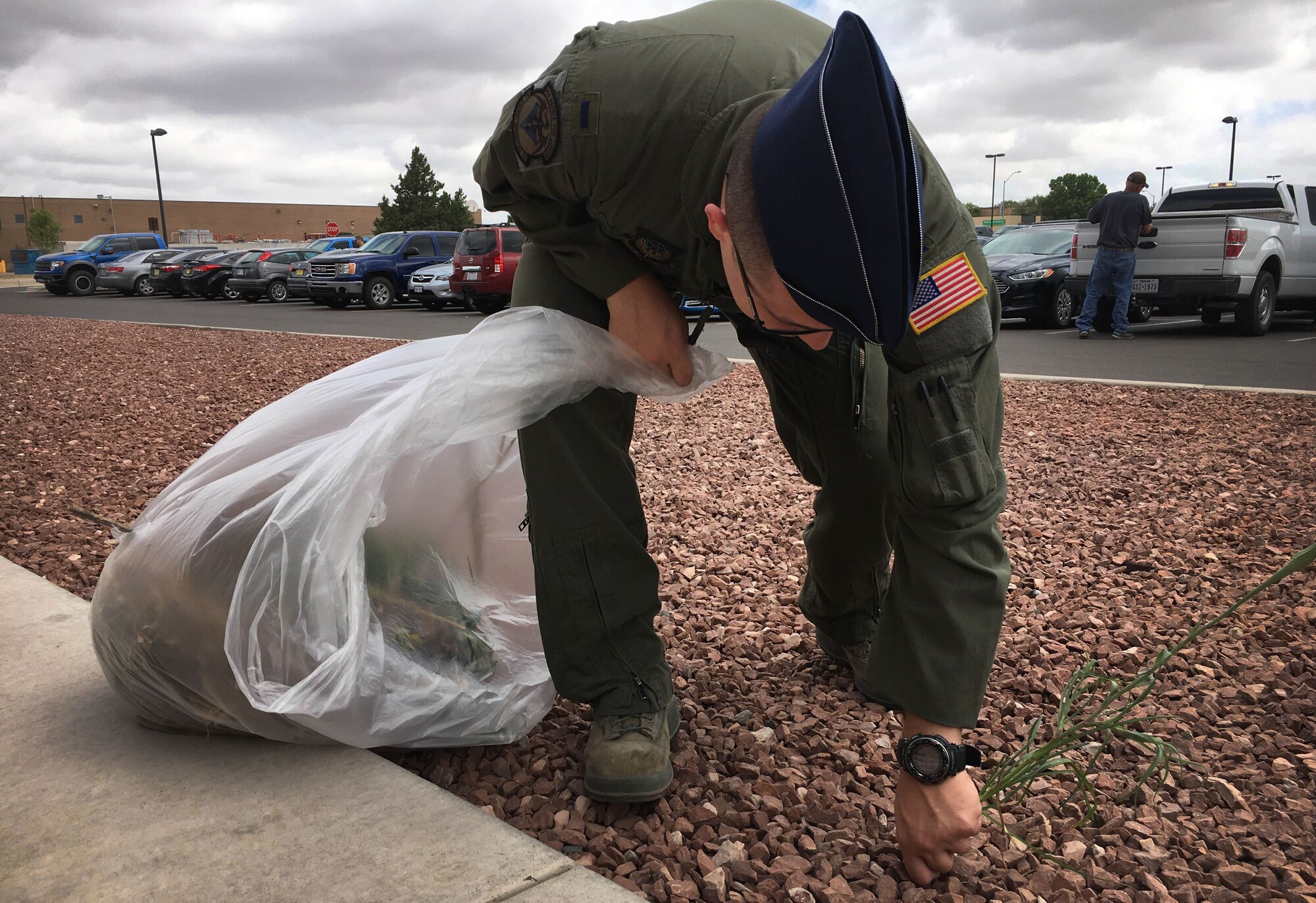 1st Lt. Malcolm Strong, 3rd Special Operations Squadron pilot, pulls out weeds outside Building 848 as part of Wing Beautification Day May 13, 2016, at Cannon Air Force Base, N.M. From maintenance to medical, flyers to finance, members of the 27th SOW took time out of their day to clean-up the Cannon Community. (U.S. Air Force photo/Staff Sgt. Alexx Pons)