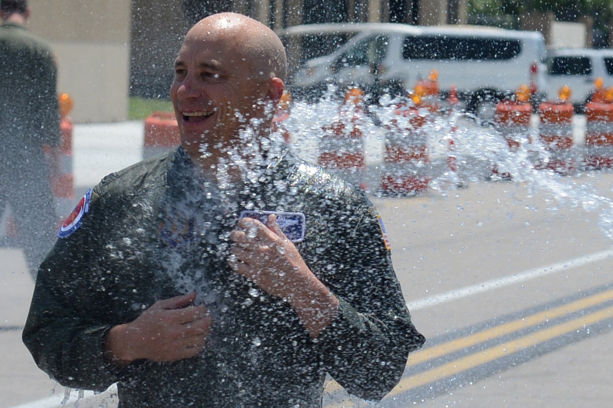 Col. David Condit, 403rd Operation Group commander, gets doused with a fire hose in honor of his final flight with the 403rd Wing May 5, 2016, Keesler Air Force Base, Mississippi. Condit has been assigned to the 403rd Wing since July 2013 and has more than 4,000 flight hours throughout his career in the Air Force. His last day with the 403rd Wing is May 15, 2016. His next assignment is as the 908th Airlift Wing commander at Maxwell Air Force Base, Alabama. (Air Force photo/Airman 1st Class Travis Beihl)
