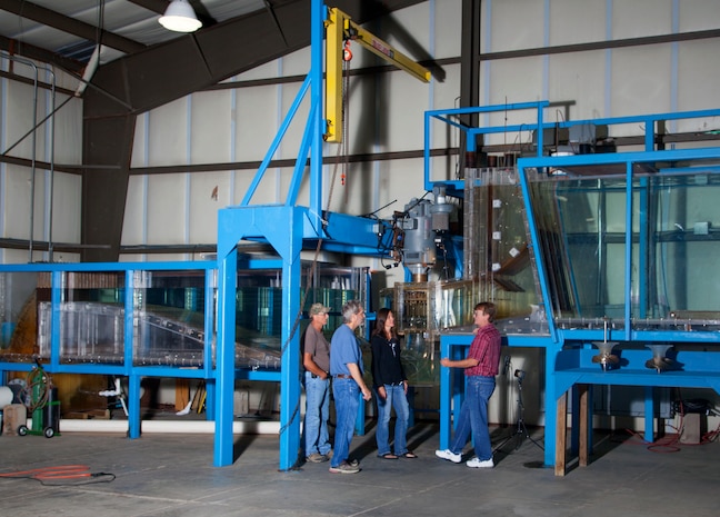 Researchers collect hydraulic data from a scale model of the new Ice Harbor Dam turbine at the U.S. Army Corps of Engineers' Engineering Research and Development Center in Vicksburg, Mississippi. The turbine model is about 1 foot wide; the actual turbine is about 23 feet in diameter.
