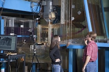 Researchers collect hydraulic data from a scale model of the new Ice Harbor Dam turbine at the U.S. Army Corps of Engineers' Engineering Research and Development Center in Vicksburg, Mississippi. The turbine model is about 1 foot wide; the actual turbine is about 23 feet in diameter.