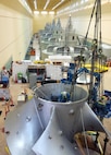Workers assembling the new high-tech replacement turbine for Ice Harbor’s hydroelectric generator Unit-2 apply heat to expand a metal ring that will lock together the turbine segments from the inside of its hub as the ring cools and shrinks back to normal size. 