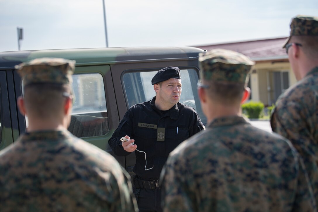 Warrant Officer Branislav Banovacki, a counter terrorism military police technician with Special Brigade, Serbian Armed Forces, shows Marines how to conduct a search for IEDs in a car during exercise Platinum Wolf 2016 at Peacekeeping Training Operations Center South Base in Bujanovac, Serbia, May 10, 2016. Reserve Marines with 4th Law Enforcement Battalion, Force Headquarters Group, Marine Forces Reserve join six other partner nations to conduct classes on peacekeeping operations and non-lethal weapons systems. (U.S. Marine Corps photo by Sgt. Sara Graham)