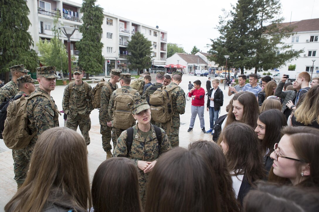 Capt. Brittney Bennett, a judge advocate with 3rd Civil Affairs Group, Force Headquarters Group, Marine Forces Reserve, speaks with young girls while participating in the program called American Corners, where they have the opportunity to teach local children about American culture and the Marine Corps during exercise Platinum Wolf 2016, in Bujanovac, Serbia, May 11, 2016. The Marines visited two American Corners sites in Bujanovac and Vranje during the exercise. The program is sponsored by the U.S. embassy and a local host institution; it aims to reinforce intercultural exchange and friendship between the two nations. (U.S. Marine Corps photos by Sgt. Sara Graham)