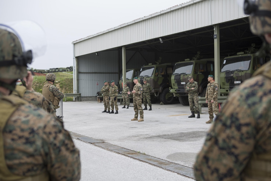 Reserve Marines with 4th Law Enforcement Battalion, Force Headquarters Group, Marine Forces Reserve, listen to classes on crowd control given by Slovenian and Serbian service members during exercise Platinum Wolf 2016 at Peacekeeping Training Operations Center South Base in Bujanovac, Serbia, May 12, 2016. Platinum Wolf brings together service members from Bosnia, Bulgaria, Macedonia, Montenegro, Serbia, Slovenia, and the United States to train in peacekeeping operations and non-lethal weapons capabilities. (U.S. Marine Corps photo by Sgt. Sara Graham)