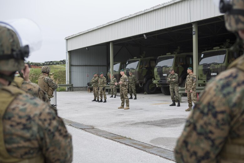 Reserve Marines with 4th Law Enforcement Battalion, Force Headquarters Group, Marine Forces Reserve, listen to classes on crowd control given by Slovenian and Serbian service members during exercise Platinum Wolf 2016 at Peacekeeping Training Operations Center South Base in Bujanovac, Serbia, May 12, 2016. Platinum Wolf brings together service members from Bosnia, Bulgaria, Macedonia, Montenegro, Serbia, Slovenia, and the United States to train in peacekeeping operations and non-lethal weapons capabilities. (U.S. Marine Corps photo by Sgt. Sara Graham)