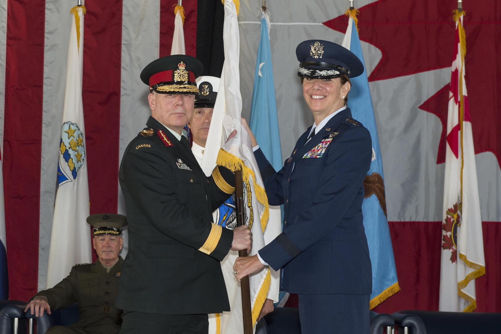 U.S. Air Force Gen. Lori J. Robinson receives the North American Aerospace Defense Command guidon from the Canadian Chief of Defence Staff, Gen. J.H. Vance signifying her acceptance of command, May 13, 2016 on Peterson Air Force Base, Colo. Gen. Robinson is the 24th NORAD commander. 